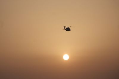 Low angle view of silhouette sun against sky during sunset