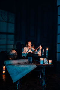 Man playing with drink at table