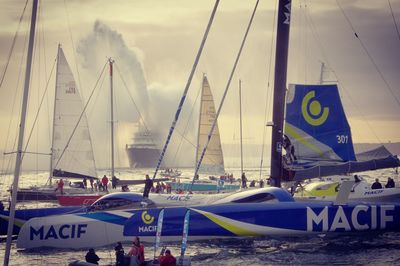 Boats moored in sea against sky