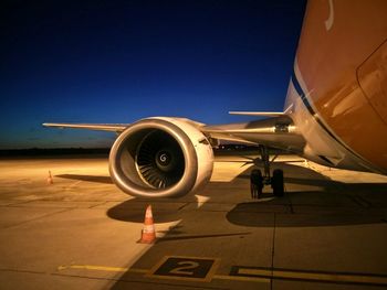 Airplane on runway against clear sky