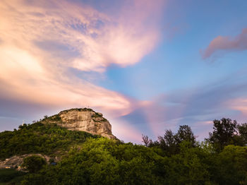Low angle view of rock formation against sky during sunset