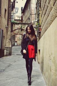 Front view of woman standing in city