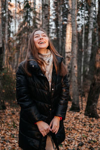 Young woman standing in forest