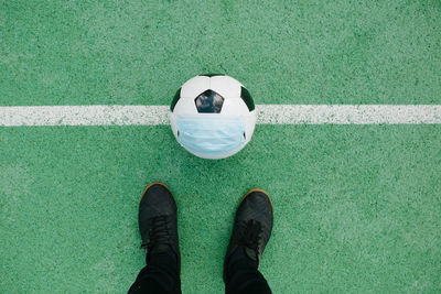 Low section of person standing on soccer field