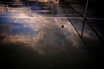 High angle view of tennis ball in wet court during monsoon