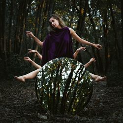 Female friends behind mirror in forest