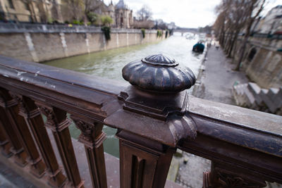 Close-up of old railing by building