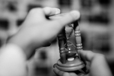 Close-up of hand holding hourglass