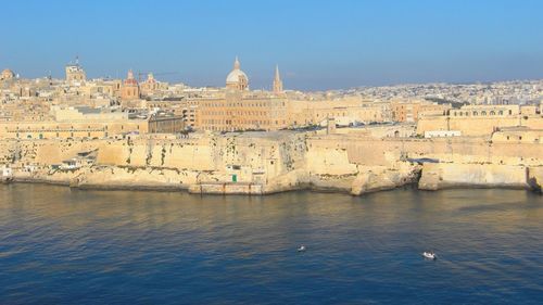 View of buildings and river against sky