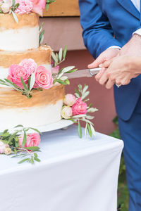 Low section of person holding rose bouquet