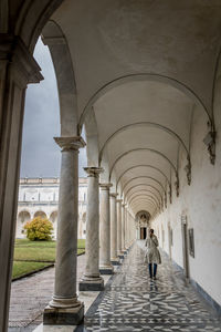 Rear view of woman walking in corridor of building