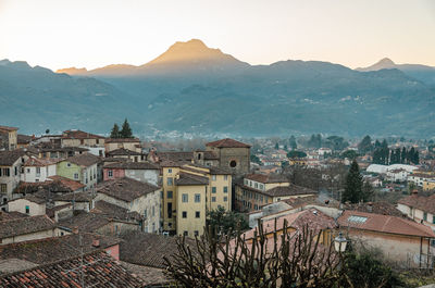 High angle view of townscape and mountains against sky