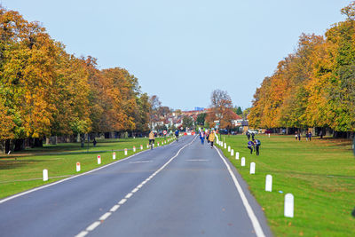 Road in park during autumn against sky