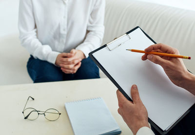 Midsection of doctor working on table