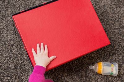 Close-up of hand holding red book