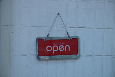 Close-up of open sign on wall