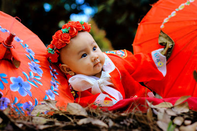 Portrait of cute baby girl looking away outdoors