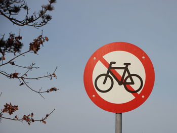 Low angle view of road sign against sky