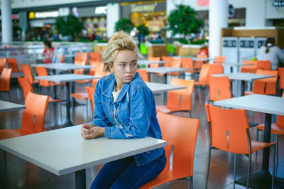 Woman sitting on chair in supermarket