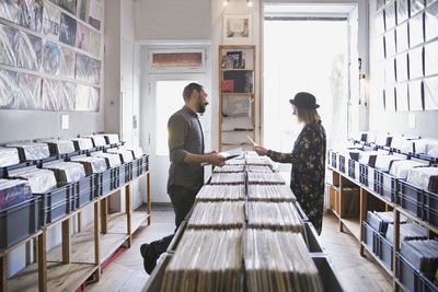 Young couple shopping for records together