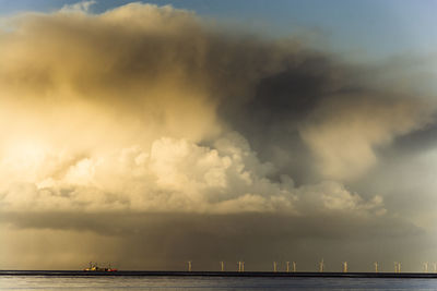 Scenic view of sea against storm clouds