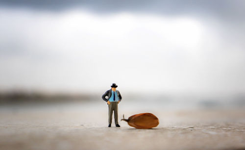 Rear view of men walking on beach