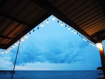 Low angle view of illuminated sea against sky