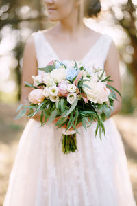 Close-up of woman holding flower bouquet