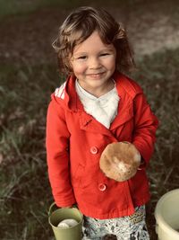 Close-up of cute girl standing on field