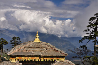 Low angle view of temple building against cloudy sky