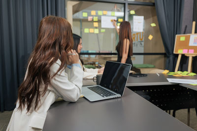 Young woman using laptop at home