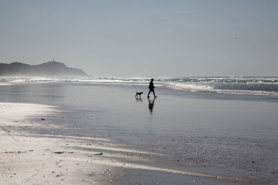 Man on beach against sky