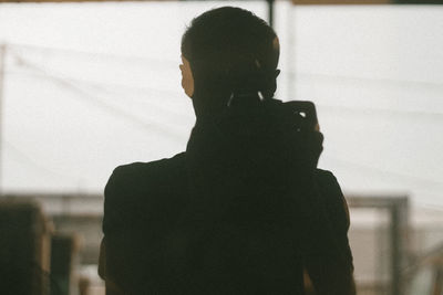 Rear view of silhouette man and woman looking at camera