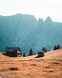 Built structure on land by mountain against sky