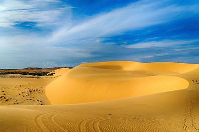 Scenic view of desert against dramatic sky