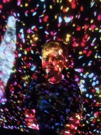 Portrait of boy with multi colored balloons