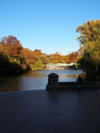 Scenic view of river against clear sky during autumn