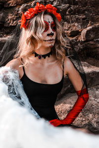 Closeup portrait of calavera catrina. young woman with sugar skull makeup and white spiderweb. dia