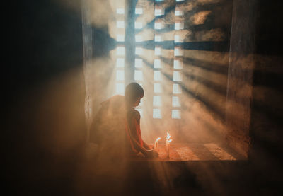 Man sitting on window at home