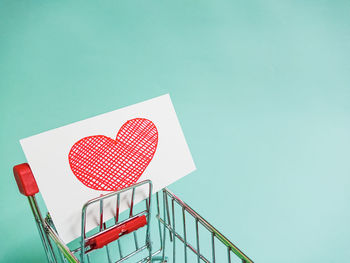 Close-up of heart shape on railing against clear sky