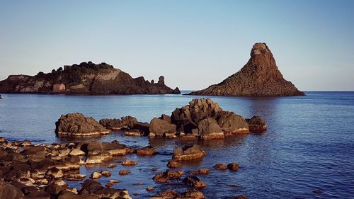 Panoramic view of sea and mountain against clear sky