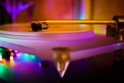 Close-up of illuminated turntable in nightclub