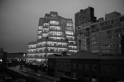 Buildings in city against sky at dusk