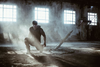 Full length of young man in abandoned room