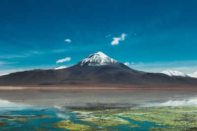 View of snowcapped mountain against cloudy sky