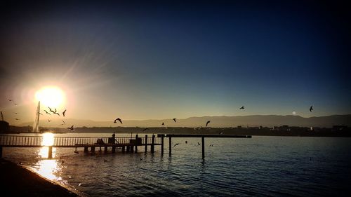 Scenic view of sea against clear sky during sunset