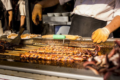 Grilling octopus on stick from street vendor