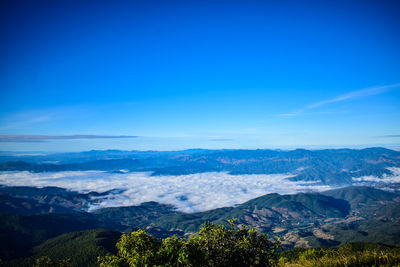 Scenic view of mountains against blue sky