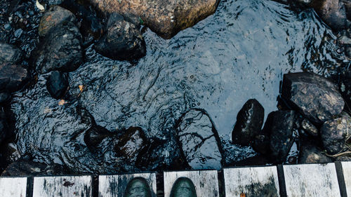 High angle view of shoe on footbridge over river