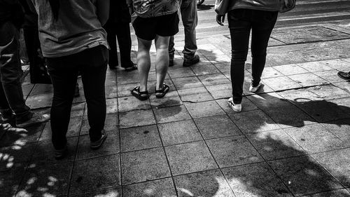 Low section of people walking on footpath